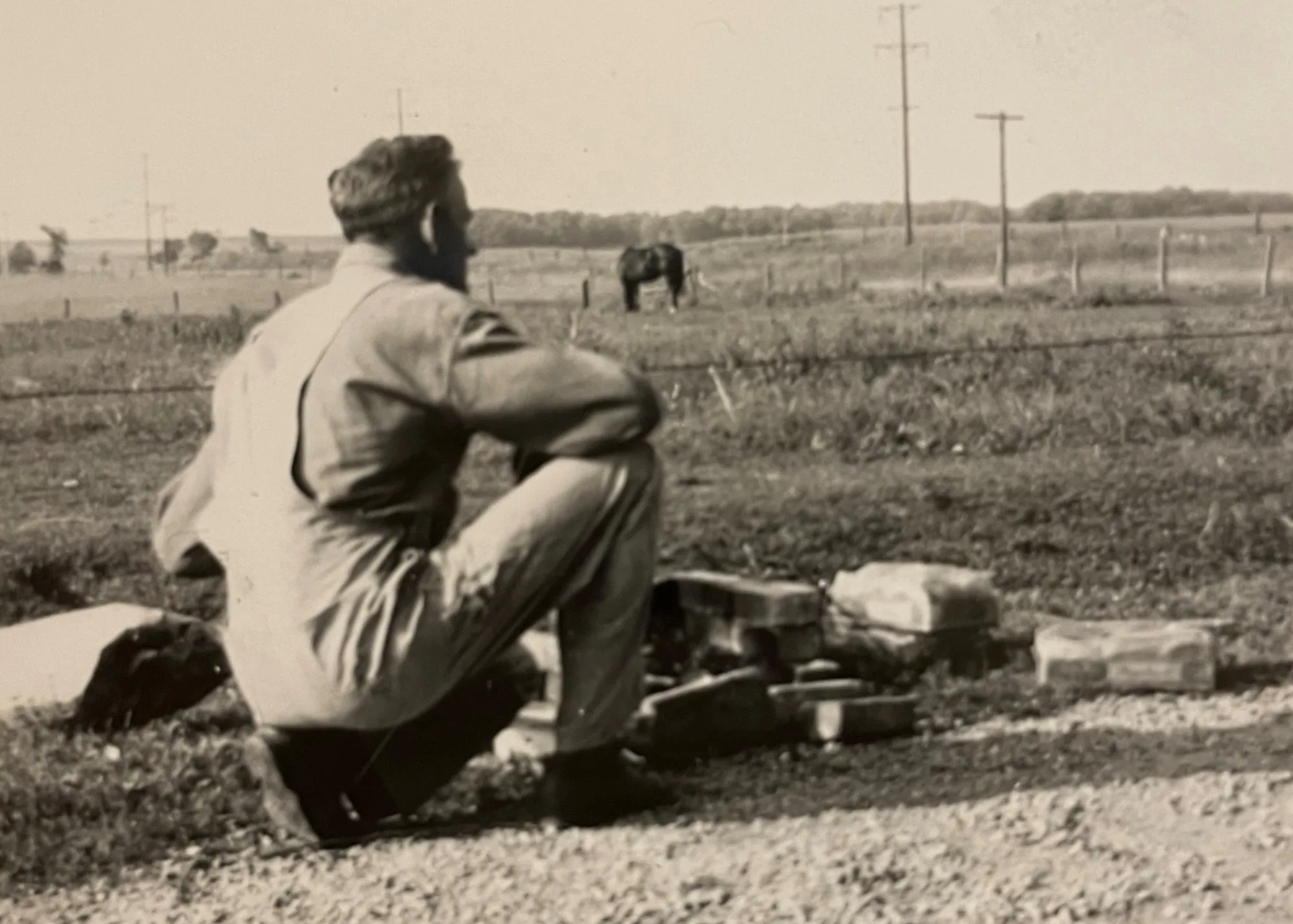Principals' grandfather on his farm evaluating the soil